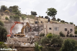 Bulldozers demolish a residential home in the Jabal Mukabbir neighborhood in East Jerusalem, May 21, 2013. From ActiveStills/Tali Mayer.